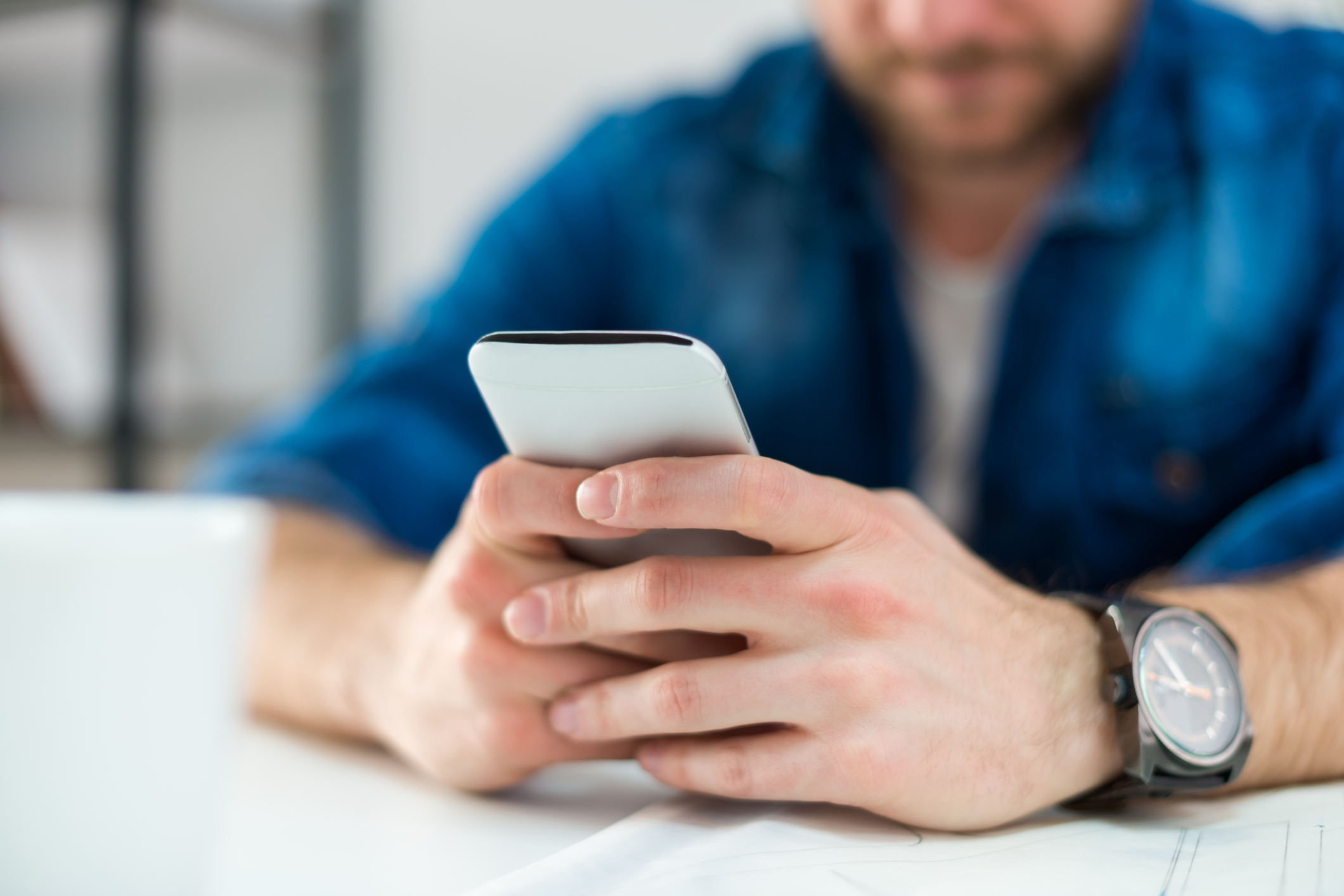 Man Typing on Smart phone